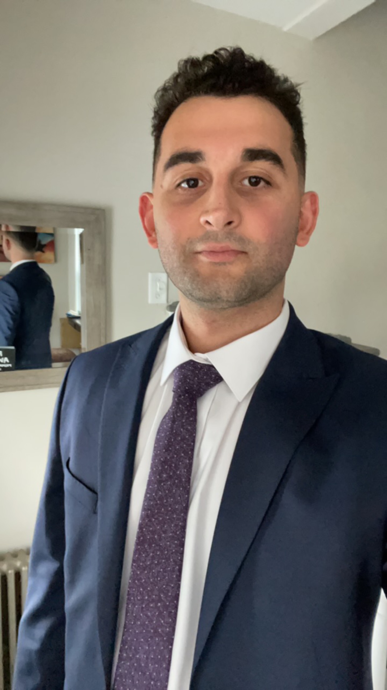 Emre Can Aslan — PhD researcher in Electrical Engineering at UFRJ, professional portrait in navy suit